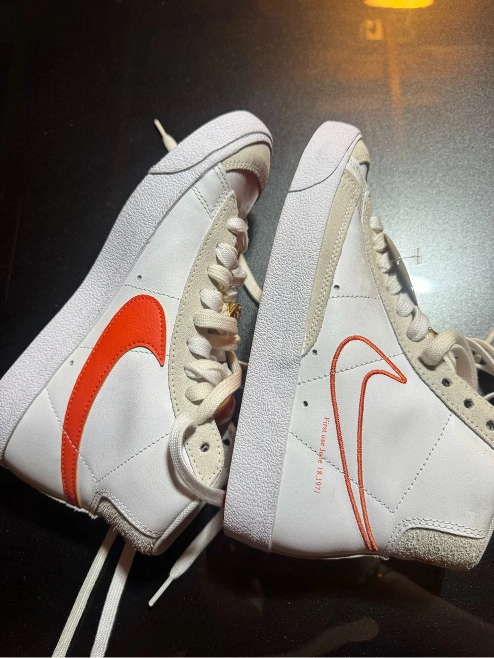 Nike White High-Top Sneakers with Orange Swoosh